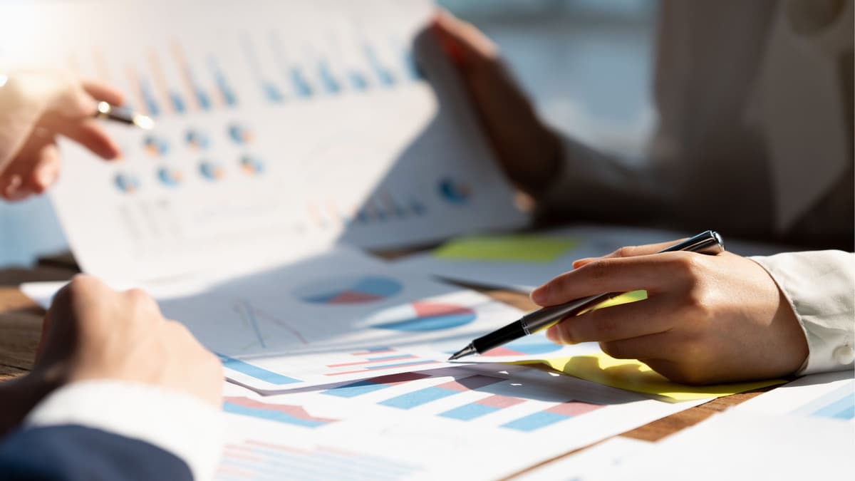 Hands reviewing business charts and documents